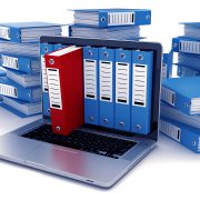 Archiviatori file ad anelli e cartonai che escono da un monitor di notebook e si accatastano in variante di blu: SGA Archiviazione Documenti a Milano e in Lombardia